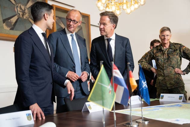 Visit to the German-Dutch Corps by Federal Chancellor Merz and Rob Jetten, Prime Minister of the Netherlands, together with Federal Chancellor Friedrich Merz, NATO Secretary General Mark Ruette listen intently to the remarks by Lieutenant General Peter Mirow, who is holding a map of Europe during a visit to the 1st German-Dutch Corps, Münster, October 1, 2026, Münste
