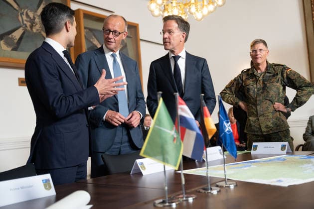 Visit to the German-Dutch Corps by Federal Chancellor Merz and Rob Jetten, Prime Minister of the Netherlands, together with Federal Chancellor Friedrich Merz, NATO Secretary General Mark Ruette listen intently to the remarks by Lieutenant General Peter Mirow, who is holding a map of Europe during a visit to the 1st German-Dutch Corps, Münster, October 1, 2026, Münste