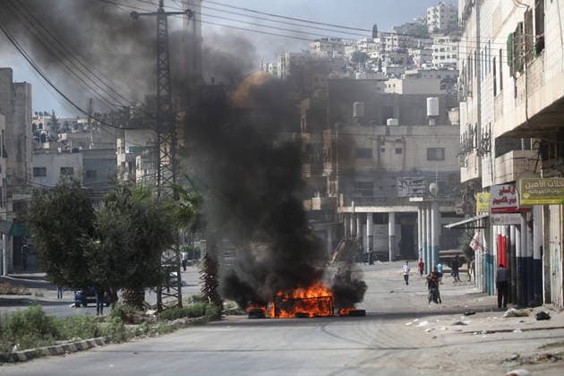 Israel enforces Security as Jewish visitors arrive to pray during the festival of Sukkot in Nablus, Palestine Palestinians set fire to tires in the streets of the Balata refugee camp in protest against the visit of Jewish settlers to Joseph s Tomb a religious site that is a point of contention between Israelis and Palestinians as Jewish visitors arrive late at night to pray there during the festival of Sukkot; the site is located in an area under the control of the Palestinian Authority. Nablus Palestine Copyright: xNasserxishatyehx xSOPAxImagesx Nishtayeh693