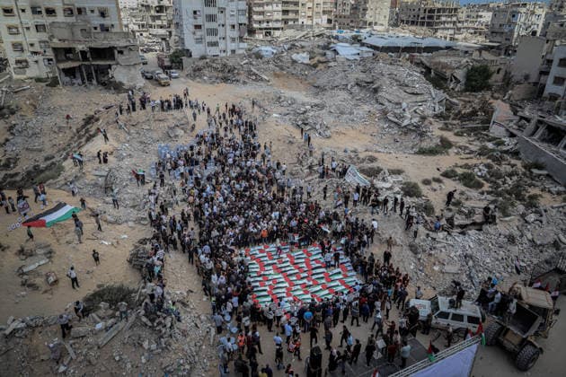 Gaza Funeral For Recovered Victims An aerial view shows a funeral gathering centered on rows of Palestinian flag-draped shrouds surrounded by crowds and extensive rubble in Gaza City, Gaza Strip, on October 1, 2026. Gaza Civil Defense said the remains were among those of 105 Palestinians recovered during a 17-day search of the Al-Taj residential block in the Al-Yarmouk area, which was struck by Israel on October 25, 2023. Gaza City Gaza Strip Palestinian Territories Copyright: xMohammedxMxSkaikx