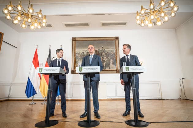Friedrich Merz, Federal Chancellor of Germany (center), with Rob Jetten, Prime Minister of the Netherlands (left), and Mark Rutte, NATO Secretary General (right), during the closing remarks at the meeting between the Federal Chancellor, the Prime Minister of the Netherlands, and the NATO Secretary General at the 1st German-Dutch Corps in Münster, Münster,