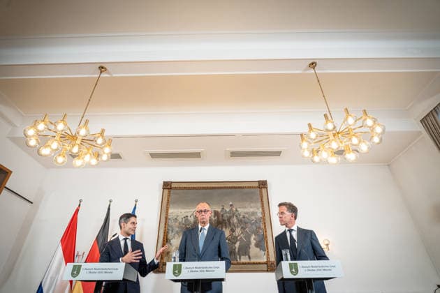 Friedrich Merz, German Chancellor (center), with Rob Jetten, Prime Minister of the Netherlands (left), and Mark Rutte, NATO Secretary General (right), during the closing remarks at the meeting between the German Chancellor, the Prime Minister of the Netherlands, and the NATO Secretary General at the 1st German-Dutch Corps in Münster, Münster, North Rhine-