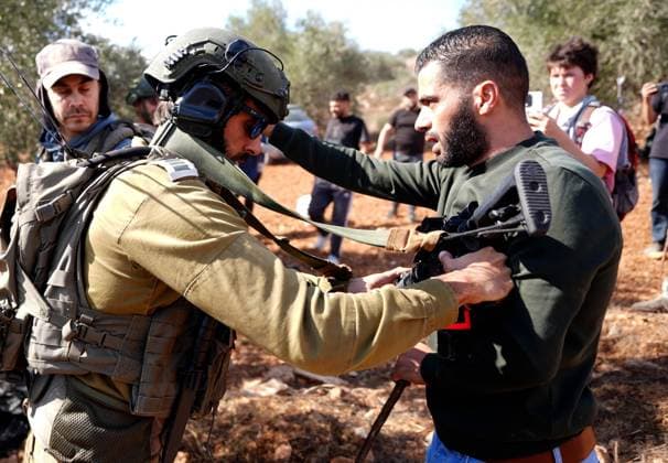 Israeli forces injure Palestinian farmer during raids on olive farms NABLUS, WEST BANK, PALESTINE - OCTOBER 2: Israeli military forces and settlers intervene against Palestinian farmers and international activists harvesting olives in the town of Beita, in Nablus, West Bank, Palestine on October 02, 2026. Israeli settlers beat the 46-year-old Palestinian man in the town of Beita, according to the Palestinian Red Crescent Society. Witnesses told Anadolu that a group of Israeli settlers fired stun grenades and tear gas at farmers in the Jabal al-Arma area, forcing them to leave. Issam Rimawi Anadolu Nablus West Bank. Editorial use only. Please get in touch for any other usage.  Copyright: x2026xAnadoluxIssamxRimawix