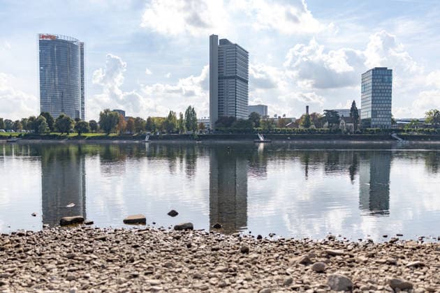 Low Water Levels on the Rhine in Bonn, October 2, 2026. Following the recent rains, the water level in Bonn is rising slightly again and stands at 64 cm, just slightly above the record low of 58 cm set on September 29. In the background is the Bonn skyline with the Post Tower, Langer Eugen, Climate Tower, and the UN Campus in Bonn-Beuel, North Rhine-Westphalia, Germany Copyright: xMarcxJohnx