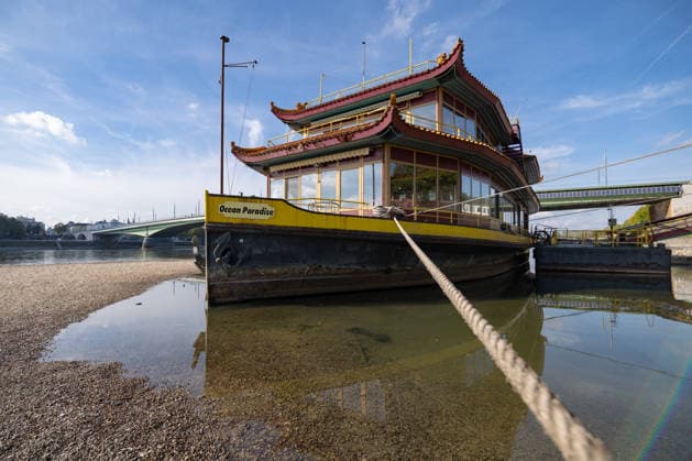Low Water Levels on the Rhine in Bonn: The China Ship at the Kennedy Bridge, October 2, 2026. View of the Kennedy Bridge in Bonn. Due to the ongoing low water levels, the so-called China Ship —the restaurant ship Ocean Paradise, which has been closed since 2023—is is almost high and dry. Na Copyright: xMarcxJohnx
