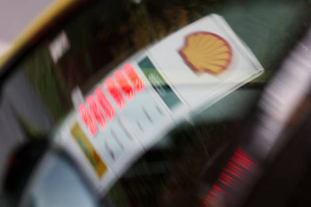 What is the outlook for fuel prices? A fuel price sign is reflected in a car’s side window. Fuel pri