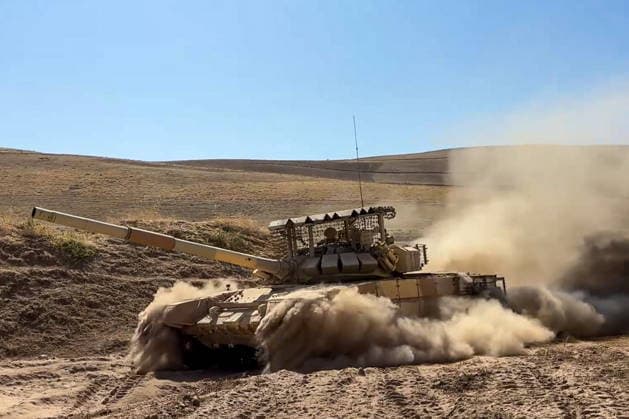 TAJIKISTAN - OCTOBER 3, 2026: Russian tank crews destroy a simulated enemy during the Tsentr Centre 2026 military exercise held at the Lyaur training ground. Video screen grab. Best quality available. Russian Defence Ministry TASS  98708964