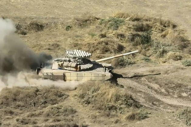 TAJIKISTAN - OCTOBER 3, 2026: Russian tank crews destroy a simulated enemy during the Tsentr Centre 2026 military exercise held at the Lyaur training ground. Video screen grab. Best quality available. Russian Defence Ministry TASS  98708968