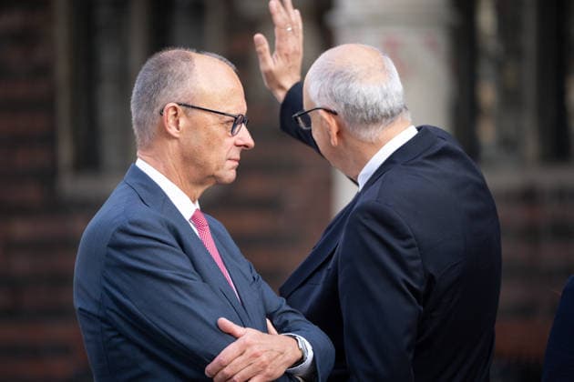 Celebrations for German Unity Day 2026 in Bremen: Federal Chancellor Friedrich Merz (CDU), together with Andreas Bovenschulte, President of the Bundesrat—who waves to the waiting crowd in response to their cheers—at the Marktplatz in Bremen during the celebrations for German Unity Day 2026, Bremen, October 3, 2026, Bremen, Germany