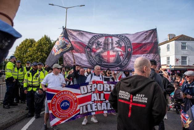 October 3, 2026, Dover, United Kingdom: Far-right protesters march with banner and flags to the harbour during a demonstration in Dover. Supporters of the English Defence League (EDL) gathered in Dover, UK to march through the town all the way to the harbour. English Defence League is an extreme far-right and Islamophobic organisation. It was founded by Tommy Robinson (pseudonym of Steven Yaxley-Lennon) in 2009. Dover United Kingdom - ZUMAs197 20261003_aaa_s197_264 Copyright: xKrisztianxElekx