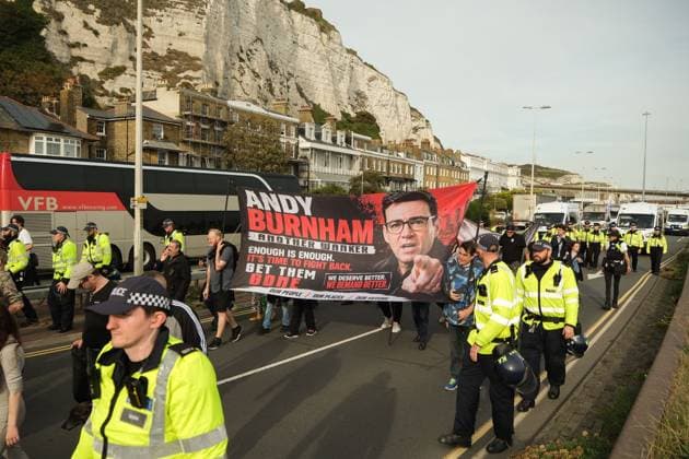 October 3, 2026, Dover, United Kingdom of Great Britain and Northern Ireland: DOVER, UNITED KINGDOM, OCTOBER 3, 2026: Anti-immigration protesters and anti-racism counter-protesters gather during rival demonstrations in Dover, Kent. Anti-immigration demonstrators carrying Union flags and St George s flags displayed banners calling for deportations and an end to small-boat crossings, while counter-protesters gathered nearby. Police maintained a significant presence between the groups and monitored the demonstrations. Dover United Kingdom of Great Britain and Northern Ireland - ZUMAq101 20261003_zna_q101_210 Copyright: xMarcxLewisx