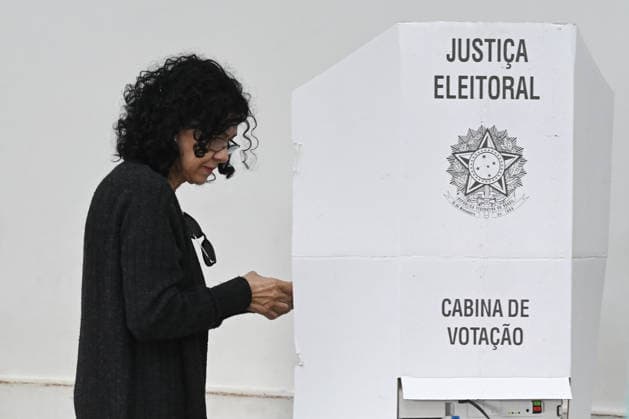 (261004) -- BRASILIA, Oct. 4, 2026 -- A voter casts her ballot at a polling station in Brasilia, Brazil, Oct. 4, 2026. Voting in the first round of Brazil s 2026 presidential election officially began at 8 a.m. (1100 GMT) on Sunday, with polling stations across the country scheduled to close at 5 p.m. (0800 GMT). Initial results are expected to be announced within a few hours after the polls close. (Photo by Xinhua) BRAZIL-PRESIDENTIAL ELECTION-VOTING LucioxTavora 
