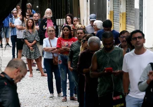 October 4, 2026, Rio De Janeiro, Rio De Janeiro, Brazil: Voters wait in line outside Escola Municipal MaroÂ­lia de Dirceu, a polling place in Brazil on Election Day as millions of citizens head to the polls in the countryÃ¢â‚¬â ¢s closely contested 2026 general election. The presidential race between incumbent Luiz InoÂ¡cio Lula da Silva and right-wing Senator FloÂ¡vio Bolsonaro has dominated the campaign, with polls showing a tight contest ahead of the October 4 first round. Brazilians are also voting for governors, senators and federal and state legislators. Rio De Janeiro Brazil  - ZUMAk251 20261004_znp_k251_001 Copyright: xBobxKarpx