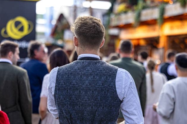 Oktoberfest 2026 in Munich, October 4, 2026: A visitor in traditional folk costume, wearing an intricately patterned vest, on the festival grounds. The 191st Oktoberfest took place from September 19 to October 4, 2026, at the Theresienwiese. The Munichnich’s Oktoberfest is one of the largest folk festivals in the world and