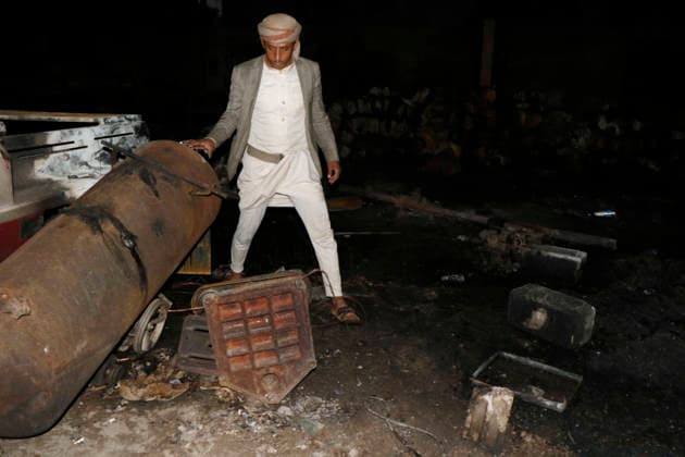 (261004) -- SANAA, Oct. 4, 2026 -- A worker inspects a sponge factory after it was struck by an airstrike carried out by a Saudi warplane in Sanaa, Yemen, on Oct. 4, 2026. Yemen s Houthi group said Sunday that Saudi Arabia had launched 106 air and missile strikes across Houthi-held areas over the past 24 hours, as the internationally recognized government announced a new military campaign to retake territory from the group amid a widening escalation in the country. (Photo by Xinhua) YEMEN-SANAA-SAUDI AIRSTRIKES MohammedxMohammed 