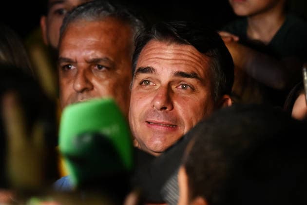 (261005) -- BRASILIA, Oct. 5, 2026 -- Flavio Bolsonaro (C), presidential candidate of Brazil s Liberal Party, is seen after the announcement of the first-round results of the presidential election in Brasilia, Brazil, Oct. 4, 2026. Brazil will hold a presidential runoff on Oct. 25 as official results showed Sunday that no candidate secured a majority of valid votes in the first round. According to results released by the Superior Electoral Court, with over 99 percent of the ballots counted, Flavio Bolsonaro, presidential candidate of Brazil s Liberal Party, garnered about 47 percent of valid votes while incumbent President Luiz Inacio Lula da Silva of the Workers Party came in second with about 45 percent. Under Brazil s electoral r