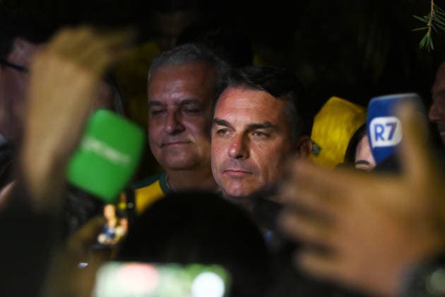 (261005) -- BRASILIA, Oct. 5, 2026 -- Flavio Bolsonaro (C), presidential candidate of Brazil s Liberal Party, is seen after the announcement of the first-round results of the presidential election in Brasilia, Brazil, Oct. 4, 2026. Brazil will hold a presidential runoff on Oct. 25 as official results showed Sunday that no candidate secured a majority of valid votes in the first round. According to results released by the Superior Electoral Court, with over 99 percent of the ballots counted, Flavio Bolsonaro, presidential candidate of Brazil s Liberal Party, garnered about 47 percent of valid votes while incumbent President Luiz Inacio Lula da Silva of the Workers Party came in second with about 45 percent. Under Brazil s electoral r