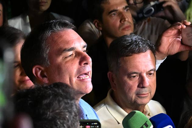 (261005) -- BRASILIA, Oct. 5, 2026 -- Flavio Bolsonaro, presidential candidate of Brazil s Liberal Party, speaks after the announcement of the first-round results of the presidential election in Brasilia, Brazil, Oct. 4, 2026. Brazil will hold a presidential runoff on Oct. 25 as official results showed Sunday that no candidate secured a majority of valid votes in the first round. According to results released by the Superior Electoral Court, with over 99 percent of the ballots counted, Flavio Bolsonaro, presidential candidate of Brazil s Liberal Party, garnered about 47 percent of valid votes while incumbent President Luiz Inacio Lula da Silva of the Workers Party came in second with about 45 percent. Under Brazil s electoral rules,