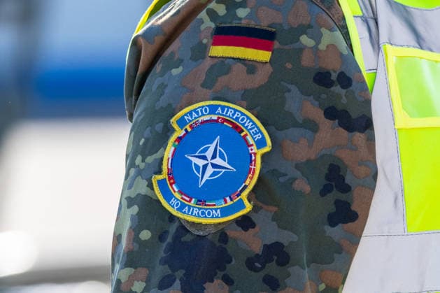 Eurofighters at Nuremberg Airport: German Air Force Conducts Dispersed Operation, Nuremberg, October 5, 2026 A German Air Force soldier wears the NATO Airpower HQ AIRCOM unit patch on the sleeve of his camouflage uniform next to the German flag. The German Air Force is conducting tests at the airport to how Eurofighters and operation 20261005-1V9A1265-M4000