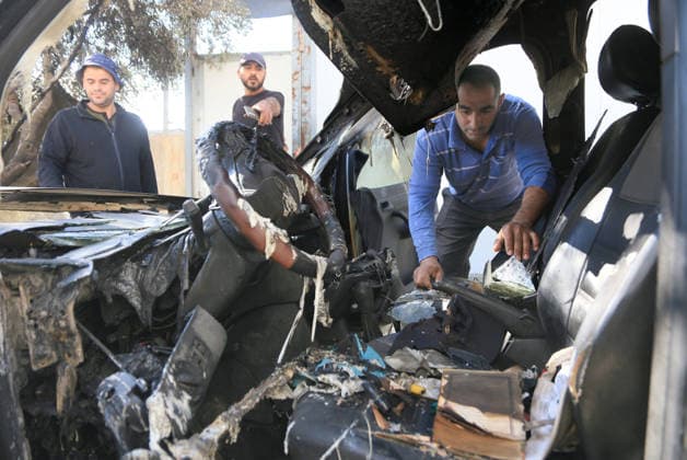 Palestinian-Israeli conflict in Nablus, Palestine - 06 Oct 2026 Palestinians inspect a vehicle that was burnt by rioting Jewish settlers who also scrawled Hebrew graffiti on the walls of homes in the village of Aqraba. Groups of rioting settlers launched attacks on Palestinian villages, they set fire on home in the village of Burqa near Ramallah, pelting Palestinian vehicles with stones, and harassing Palestinian farmers who were harvesting olive. Nablus Palestine Copyright: xNasserxishatyehx xSOPAxImagesx Nishtayeh733
