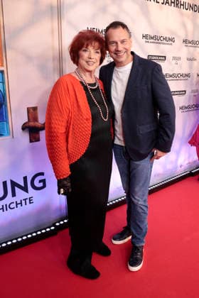 Regina Ziegler and Sebastian Fitzek attend the premiere of *Heimsuchung: The Beloved* at Kino International on October 6, 2026, in Berlin, Germany. *Heimsuchung: The Beloved* premiere in Berlin, Germany