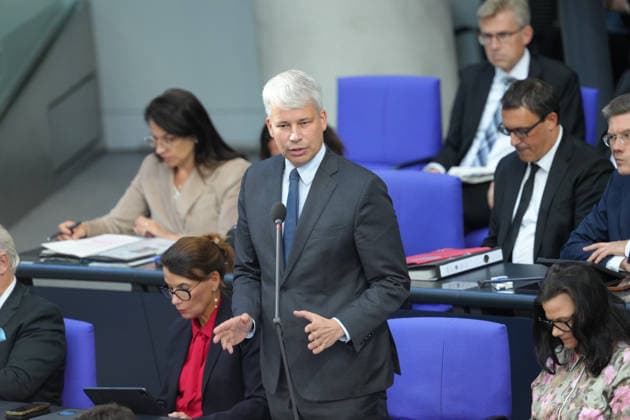 German Bundestag, 98th Plenary Session: Transportation Minister Steffen Bilger answers questions from members of parliament with expressive facial expressions and gestures from his seat on the government bench during the questioning of the federal government at the 98th session of the German Bundestag in Berlin, October 7, 2026, Berlin, Berlin, Germany