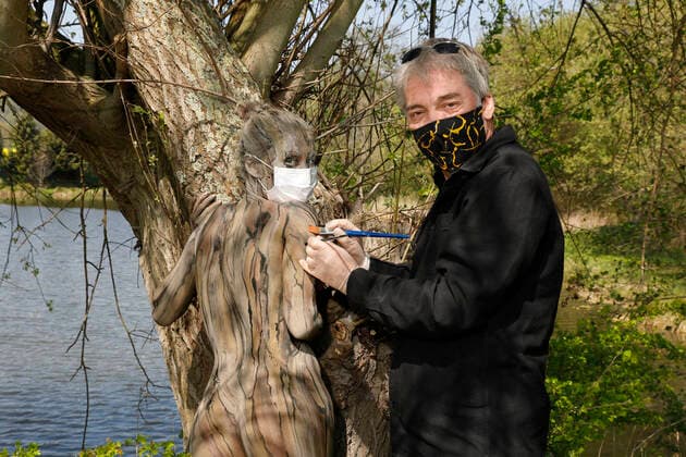 Artist Jörg Düsterwald and model Lisa during Corona crisis at the Nature Art Bodypainting in Springe