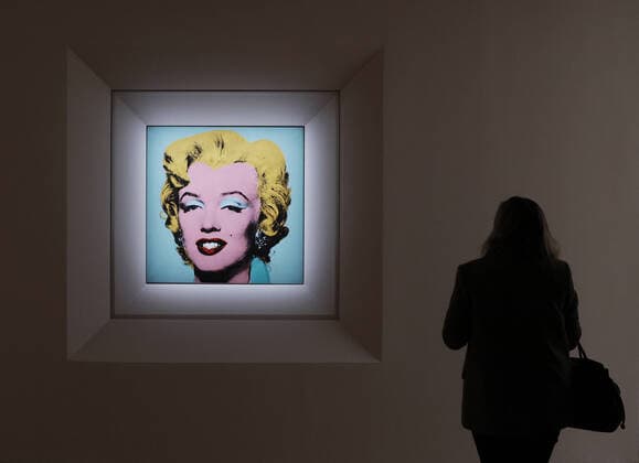 Marilyn Monroe portrait by Andy Warhol auctioned for record price, archive images