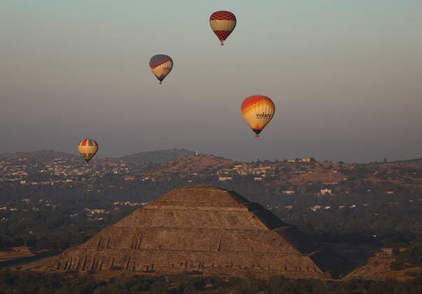 Mexico, hot air balloons flying at dawn near the Pyramid of the Sun in Teotihuacan