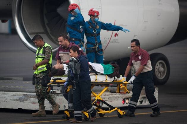 Injured tourists are led back to Mexico