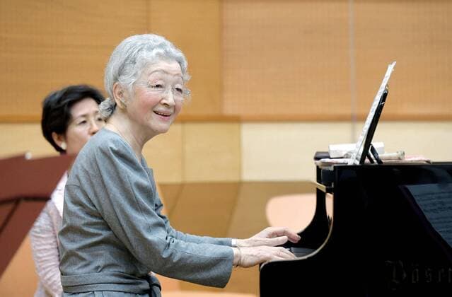 Empress Michiko plays the piano at a music class