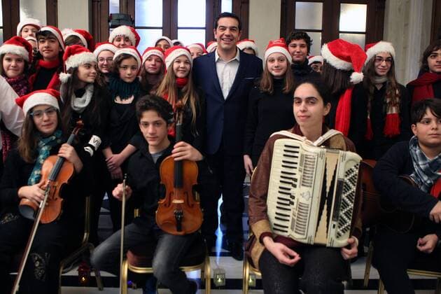 Tsipras listens to Christmas carols of a music school in Athens
