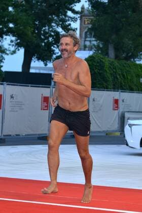 Venice Film Festival - Ammore e Malavita - True Love Film Premiere: Corrado Sassi in swimming trunks on the red carpet