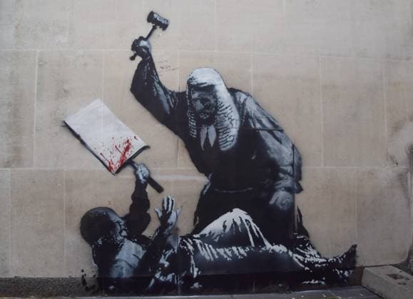 Work by street artist Banksy removed from the Royal Courts of Justice in London for 100,000 euros, archive images
