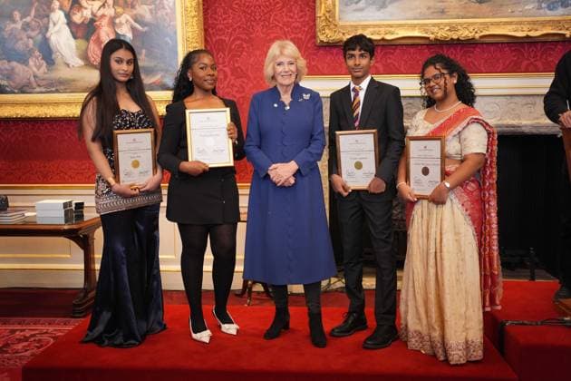 Queen Camilla with the winners of the Queens Commonwealth Essay Competition in London