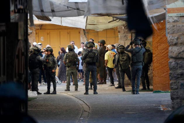 Middle East conflict, West Bank, Israeli soldiers secure weekly tour of settlers in Hebron