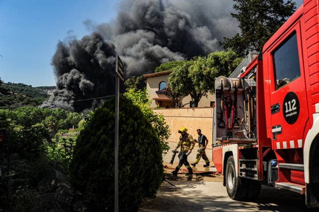 Spain, fire brigade extinguishes fire on industrial site in Orrius near Barcelona