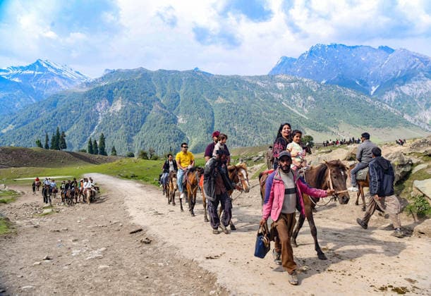 India, tourists riding horses in Jammu and Kashmir