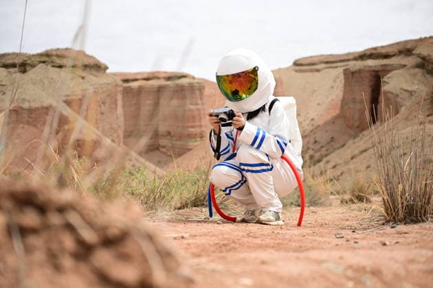 China: Tourists dressed as astronauts at the Alien Valley Geopark in Zhangye