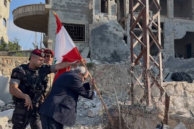 War in the Middle East, Lebanon: Prime Minister Nawaf Salam lays a national flag on a damaged road in southern Zawtar al-Gharbiya