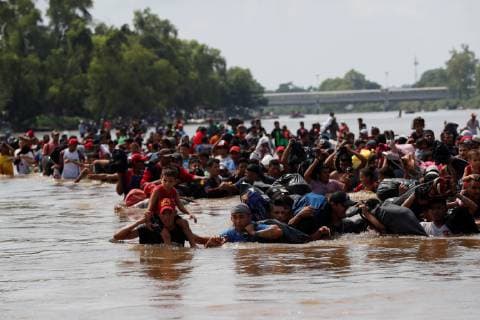 Guatemala, refugees from Honduras crossing border river to Mexico