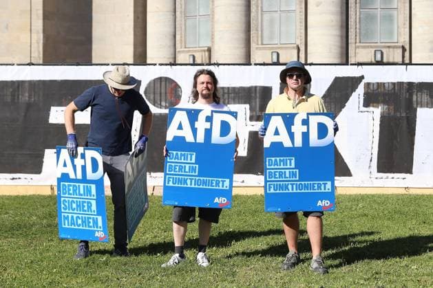 Berlin, the Volksbad in front of the Volksbühne, people holding AfD posters