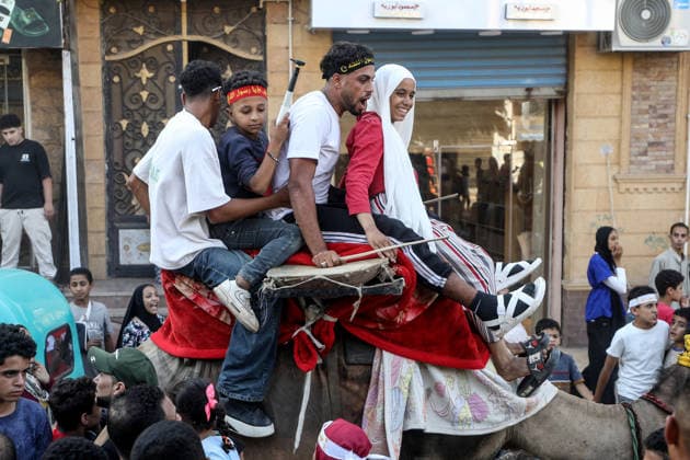 Egypt, Mawlid an-Nabi: People parade through Shama on camels, singing