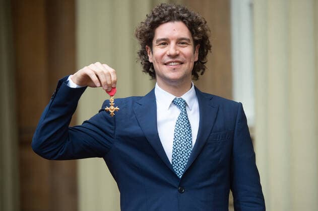 Robin Ticciati presents his OBE after the award ceremony at Buckingham Palace in London