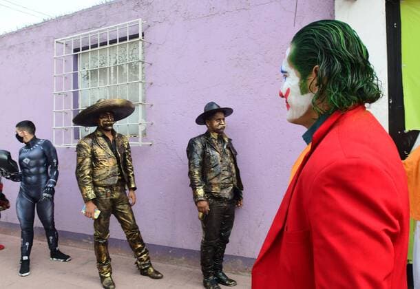 Coronavirus in Mexico, disguised street performers receive food parcels in Mexico City
