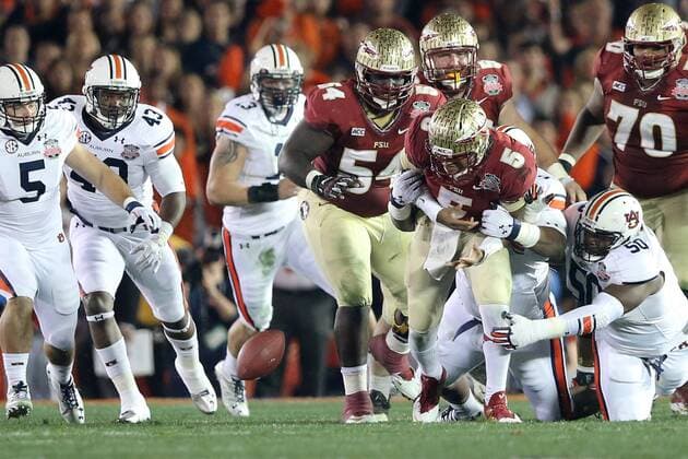 Jan. 6, 2014 - Pasadena, California, United States of America - Quarterback Jameis Winston 5 of the Florida State Seminoles is stripped of the ball by defensive lineman Angelo Blackson 98 of the Auburn Tigers, causing a fumble. During the BCS Championship Game in Pasadena, California. Between the 1 ranked Florida State Seminoles and the 2 ranked Auburn Tigers. The final game of the Bowl Championship Series, before moving to a four team playoff system. NCAA College League USA Football 2014 - Jan 6 - BCS Championship Game - Florida St vs Auburn - ZUMAl30