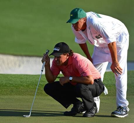 April 11, 2015 - Augusta, GA, USA - Phil Mickelson, left, and his caddie, Jim Bones Mackay line up a putt on the 18th green during the third round of the Masters at Augusta National Golf Club on Saturday, April 11, 2015, in Augusta, Ga. The Masters, Day 3 - ZUMAm67_