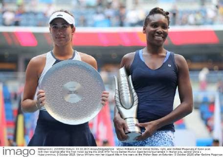 Venus Williams of the United States, right, and Garbine Muguruza of Spain pose with their trophies after the final match during the 2015 WTA Tennis Damen Wuhan Open tennis tournament in Wuhan city, central China s Hubei province, 3 October 2015. Venus Williams won her biggest title in five years at the Wuhan Open on Saturday (3 October 2015) after Garbine Muguruza quitted, making her the fifth player to pull out mid-match in the late-season tournament. Williams took the first set and was three games up in the second when the Spaniard stopped play at 53 minutes, handing the American veteran the 47th title win of her career, and her first victory at a WTA Premier Five event since she beat Victoria Azarenka in 2010 in Dubai. Wimbledon finalist Muguruza, ranked world number eight, 16 places ahead of American veteran Williams, had a tough semi-final against Germany s Angelique Kerber, winning in straight sets but falling during the closing tie break and injuring her ankle. But the 21-year-old said it was exhaustion not injury that made her pull out. Venus wins 47th career title as Muguruza quits Wuhan Open final pbu340128_18