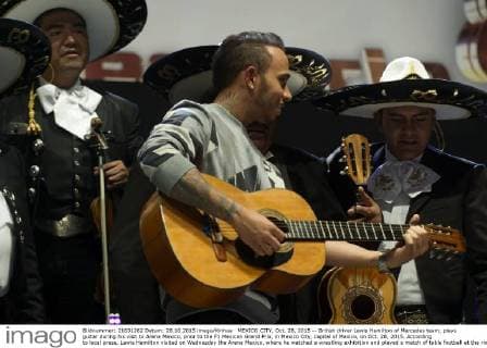 MEXICO CITY, Oct. 28, 2015 -- British driver Lewis Hamilton of Mercedes team, plays guitar during his visit to Arena Mexico, prior to the F1 Mexican Grand Prix, in Mexico City, capital of Mexico, on Oct. 28, 2015. According to local press, Lewis Hamilton visited on Wednesday the Arena Mexico, where he watched a wrestling exhibition and played a match of table football at the ring with Mexican soccer player Oribe Peralta. The F1 Mexican Grand Prix will be held from Oct. 30 to Nov. 1, in Mexico City. ) (SP)MEXICO-MEXICO CITY-AUTOMOBILE-F1 OSCARxRAMIREZ