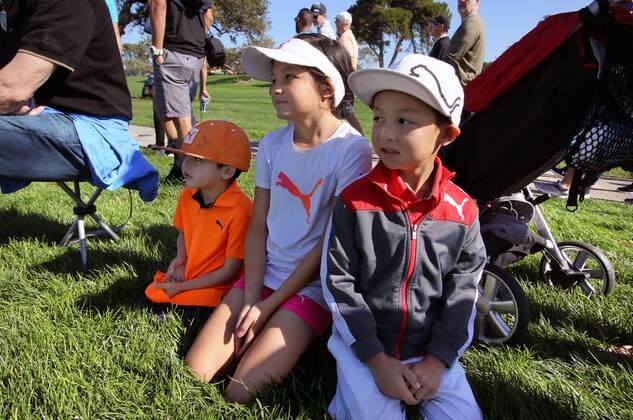 Jan. 29, 2016 - San Diego, California, United States - January 29, 2016, San Diego, California, USA_ Farmers Insurance Open Day 2- Adrian Kahler, 5, left, with his sister Jasmine, 10, and brother Kenyon, 6, of Carlsbad, watch Rickie Fowler pass by on the 4th. fairway. They re Rickie Fowler fans. _Mandatory Photo Credit: Photo by Golf 2016 - Farmers Insurance Open - Day 2 - ZUMAs44_